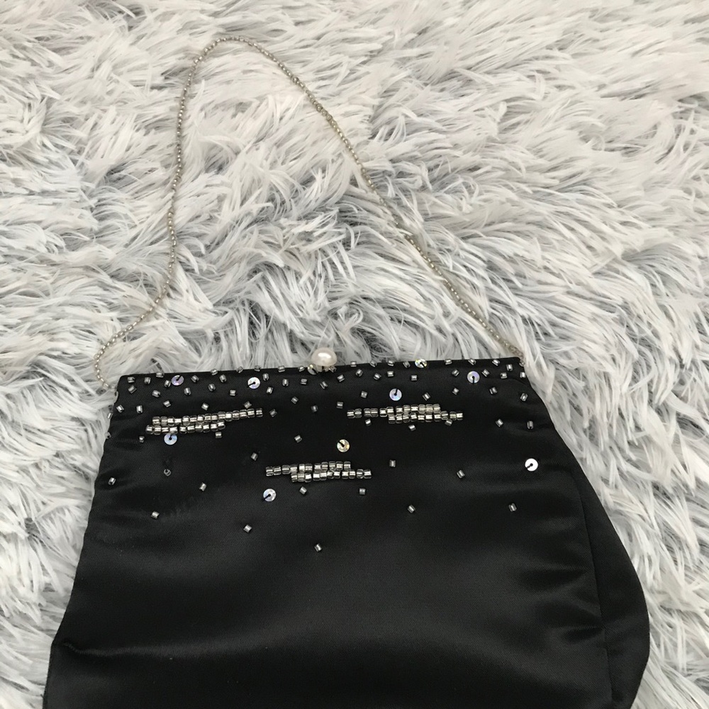 Black little bag with pearl button closure